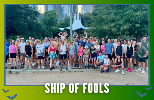 A large group of people in athletic wear poses outdoors in front of trees and a city skyline, representing the Cafecito Run Club during their KickOff Week. The text “SHIP OF FOOLS” appears at the bottom of the image, with bat graphics in the corners, highlighting the excitement of this special Group Run. Austin Marathon Half Marathon & 5K