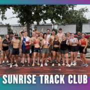 A diverse group of runners in athletic gear poses together and smiles on a wet outdoor track in South Austin, celebrating the start of KickOff Week. The image reads “SUNRISE TRACK CLUB” at the bottom with a blue-to-purple gradient border, capturing the energy of this welcoming group run. Austin Marathon Half Marathon & 5K