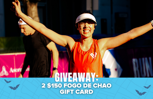 A smiling woman in a visor and running gear raises her arms at a race. Text overlay reads: “GIVEAWAY: 2 $150 FOGO DE CHAO GIFT CARD.” Blue banner with bats is at the bottom. Enter now for a chance to win your entry back and score a handy travel shoes bag!. Austin Marathon Half Marathon & 5K