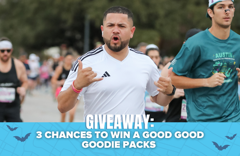 A man running in a race with others, making a shaka hand gesture. Text below reads: “GIVEAWAY: 3 CHANCES TO WIN A GOOD GOOD GOODIE PACKS and an LSKD Running Kit,” with a blue background and bat graphics. Austin Marathon Half Marathon & 5K